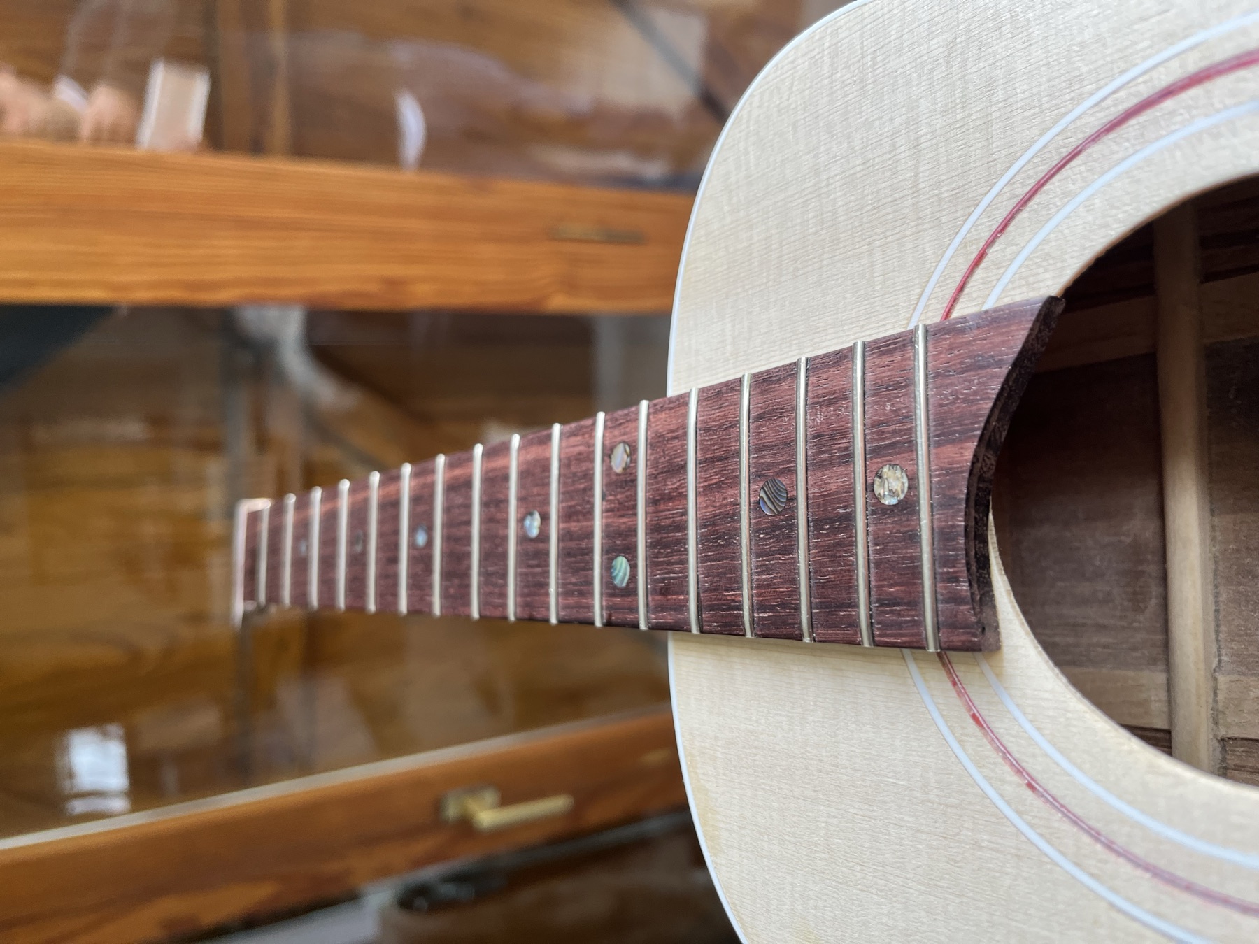 Rosewood fretboard and guitar neck looking down toward the soundhole